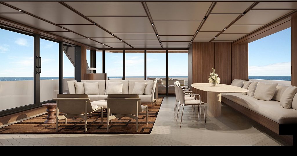 Yacht saloon with lounge seating and dining table, floor-to-ceiling windows overlooking the sea