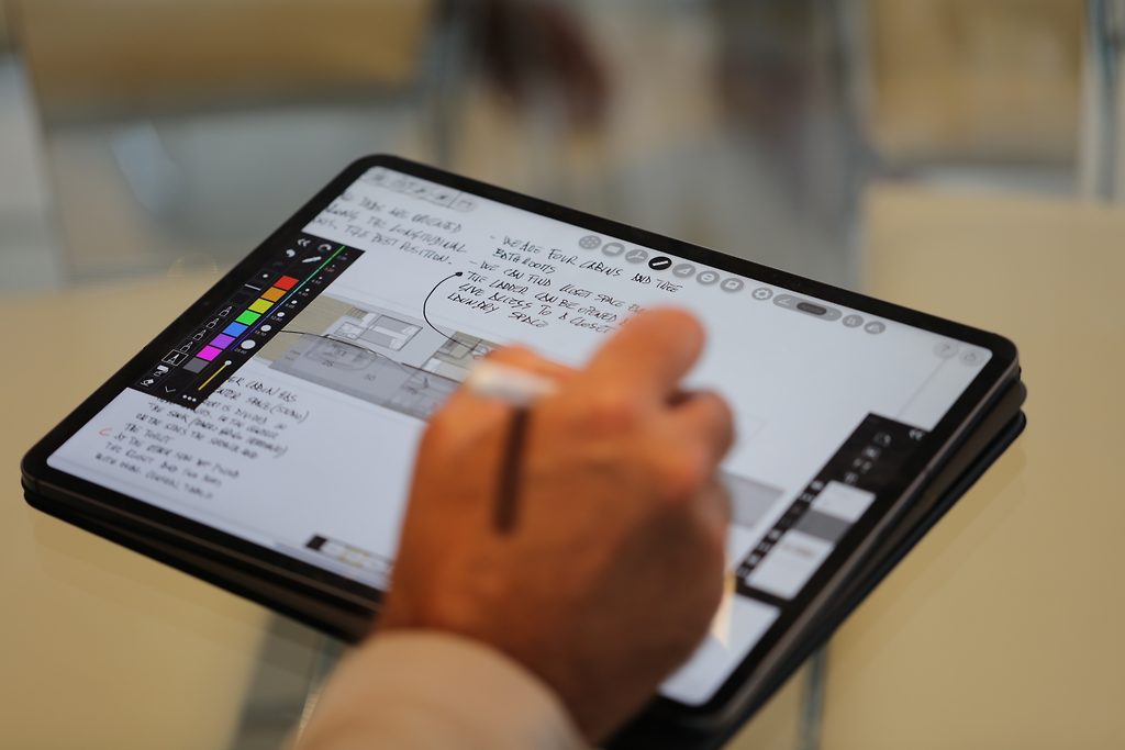 Hand sketching a yacht layout with a stylus on a tablet