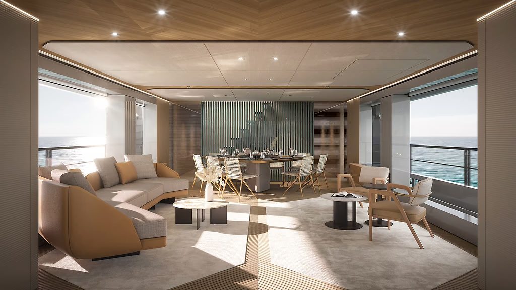 Salon de yacht avec canapé d'angle, table à manger et grandes baies vitrées donnant sur la mer