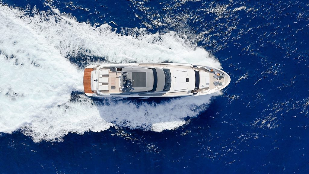Motoryacht fährt mit hoher Geschwindigkeit, Luftaufnahme des Kielwassers auf offener See