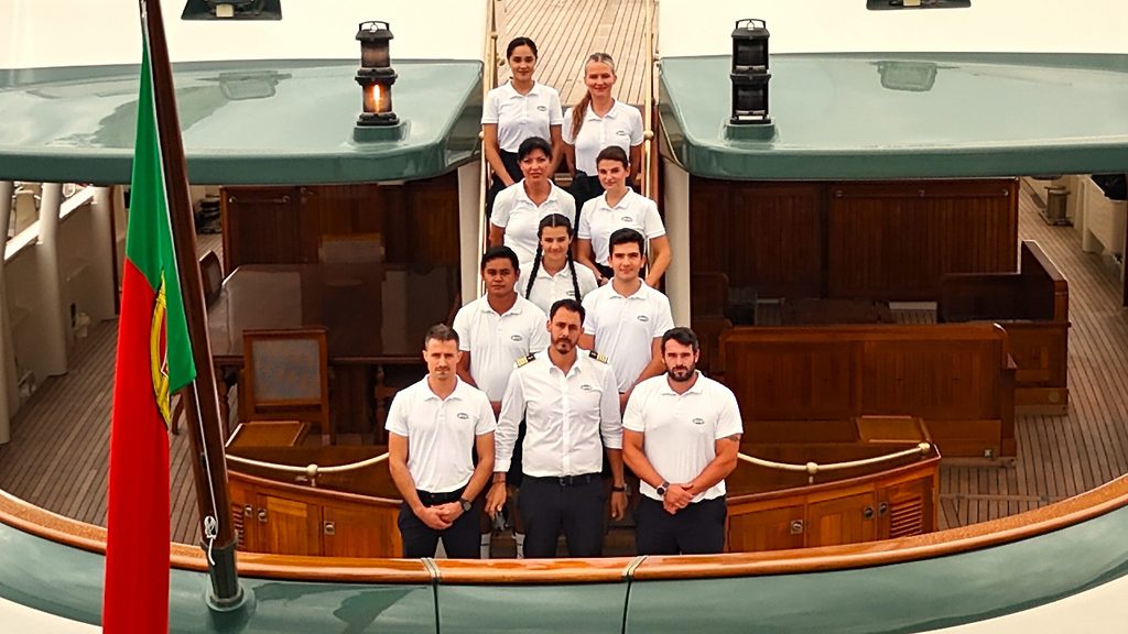 Crew auf der Treppe des Achterdecks einer klassischen Motoryacht