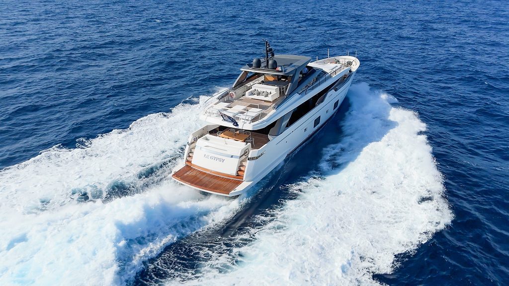 Motor yacht cruising at speed on open water, seen from above