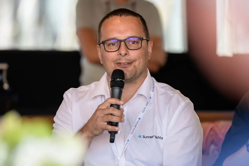 Sunreef Yachts representative speaking into a microphone at an event