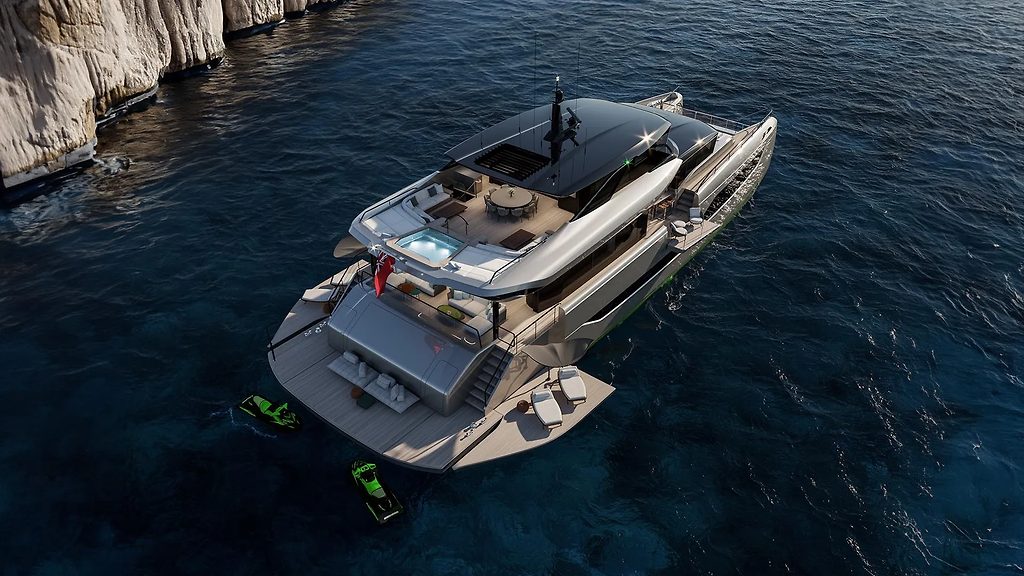 Motor yacht anchored near cliffs, aerial view with sundeck and jet skis