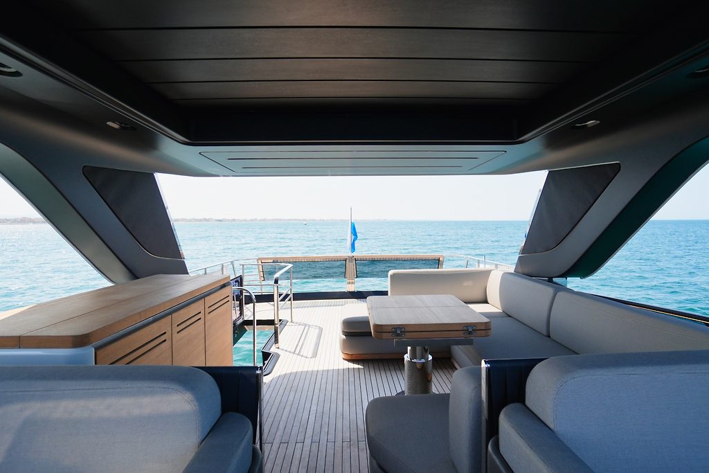 Aft cockpit lounge and swim platform of a motor yacht, at sea