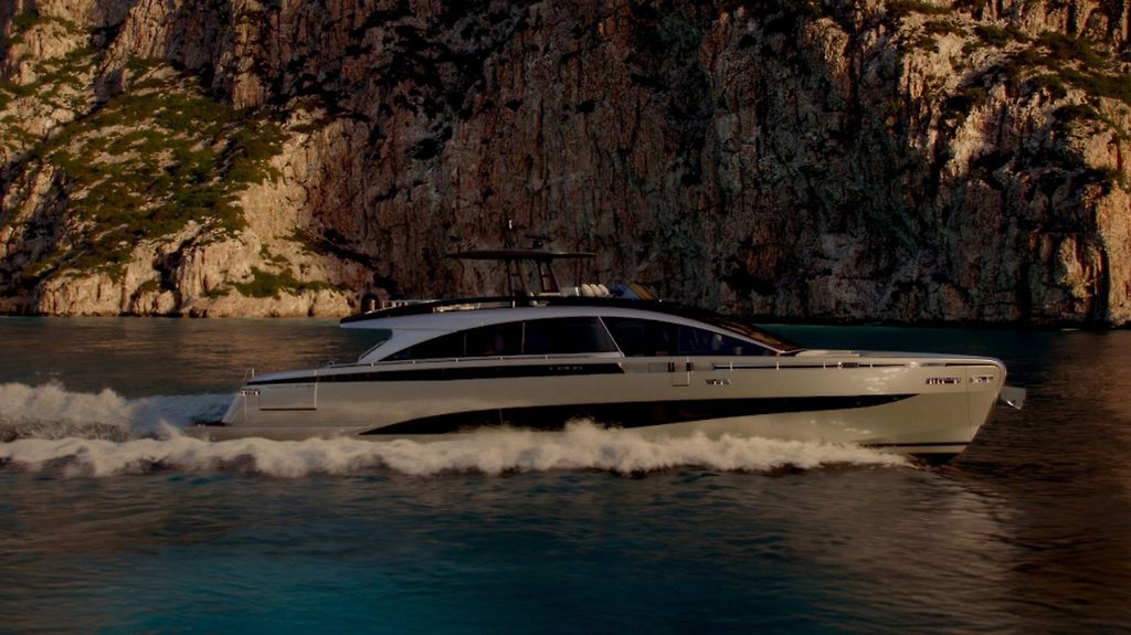 Yacht a motore in navigazione veloce lungo una costa rocciosa