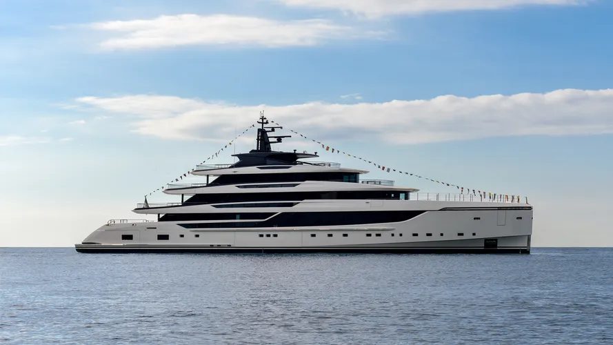 Superyacht decorated with signal flags, anchored at sea